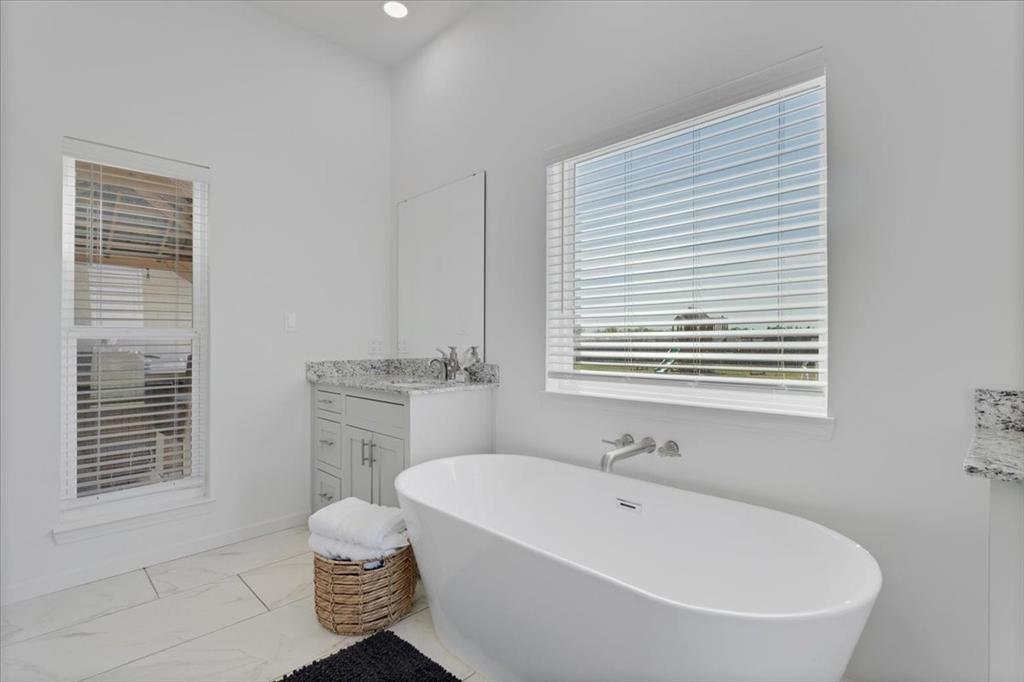 6514 Old Clarksville Road Reno, TX 75462 - Photo 22 of 27 a bathroom with a granite countertop sink and a mirror