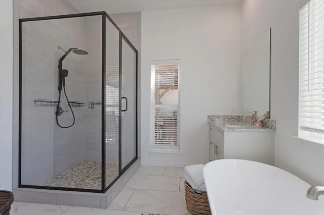 a bathroom with a granite countertop shower and a toilet