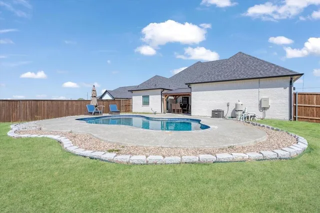 a view of a house with a yard and garage