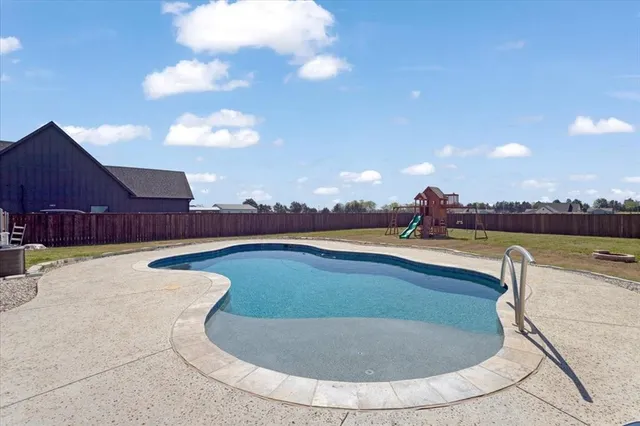 a view of a swimming pool with a yard