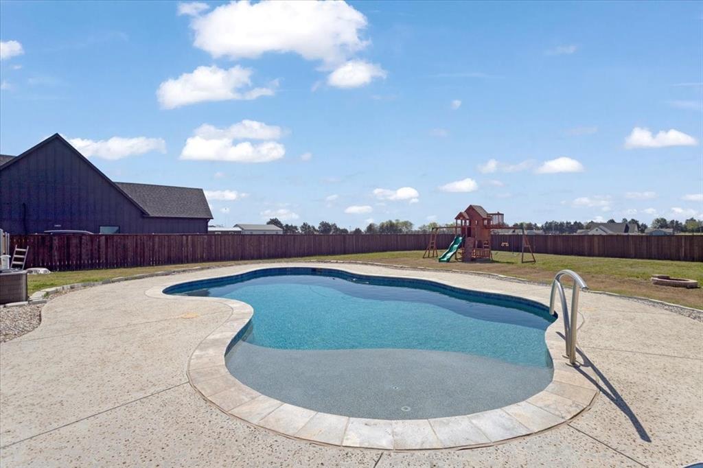 6514 Old Clarksville Road Reno, TX 75462 - Photo 5 of 27 a view of a swimming pool with a yard