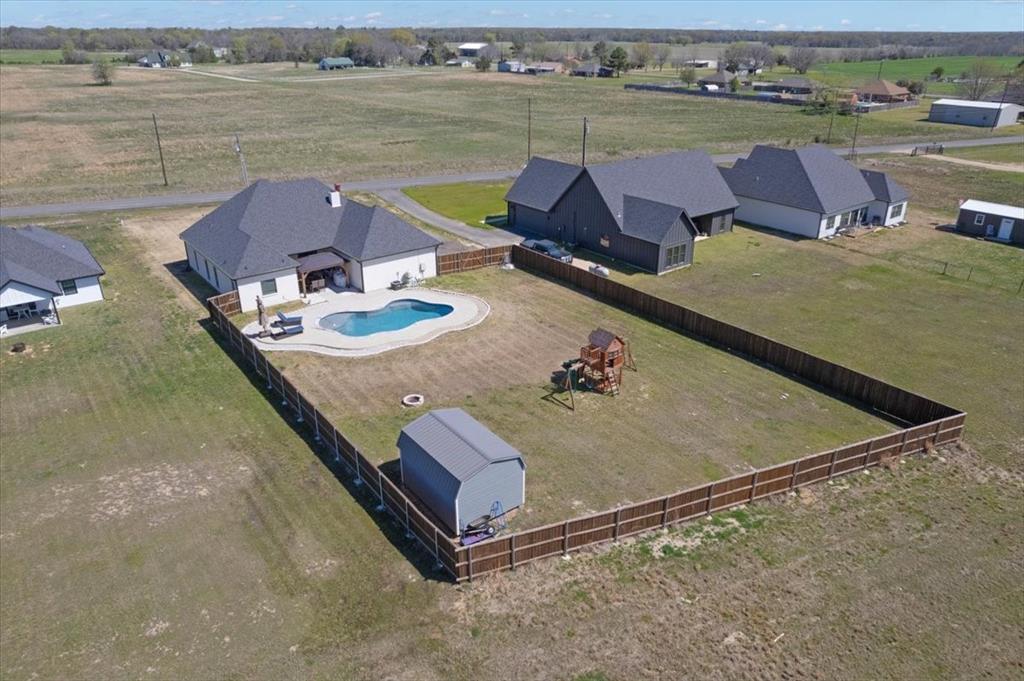 6514 Old Clarksville Road Reno, TX 75462 - Photo 8 of 27 an aerial view of a house with outdoor space and lake view