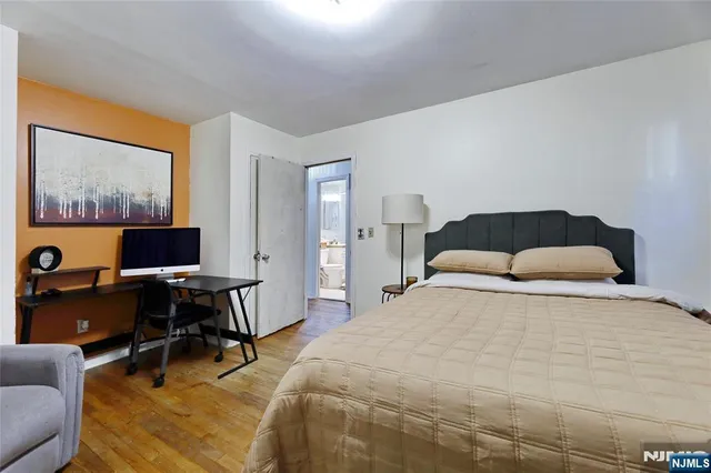 a bedroom with a workspace