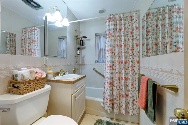 a bathroom with a sink toilet vanity and shower