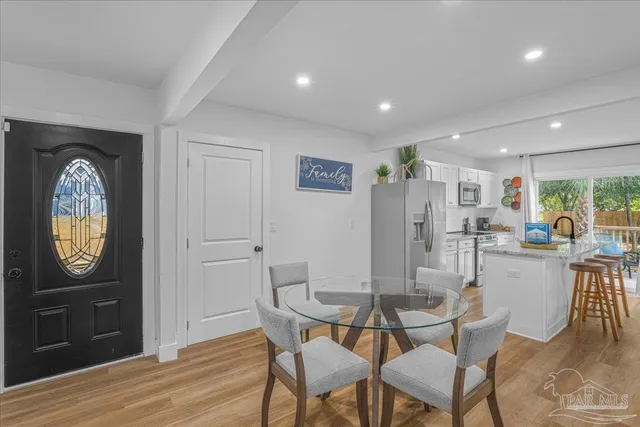 a dining room with furniture and a window