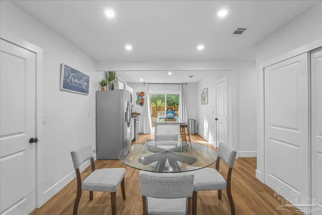 a dining room with furniture and wooden floor