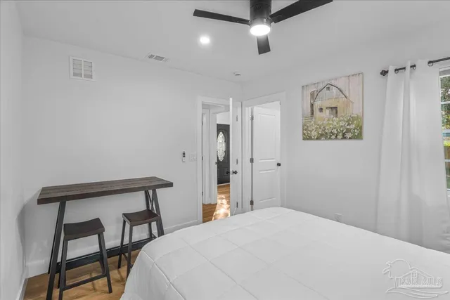 a bedroom with a bed and a window