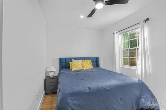 a view of a hallway with entryway wooden floor and front door