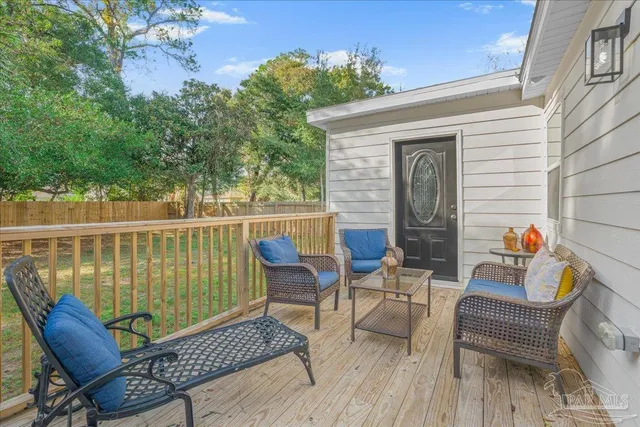 a view of a house with a backyard and a tree