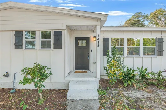a front view of a house with a garden