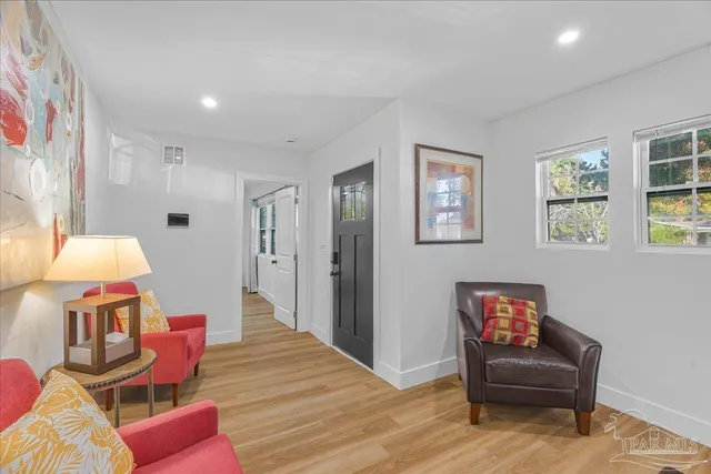 a living room with furniture and a chair