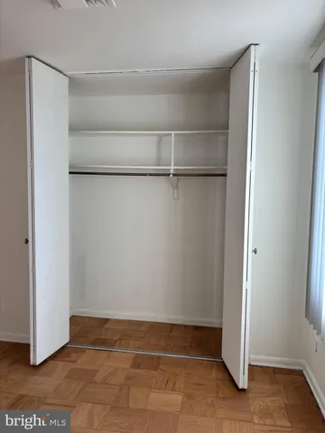 a view of an empty walk in closet with empty racks