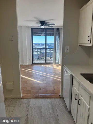 a view of an empty room with a fireplace and a window