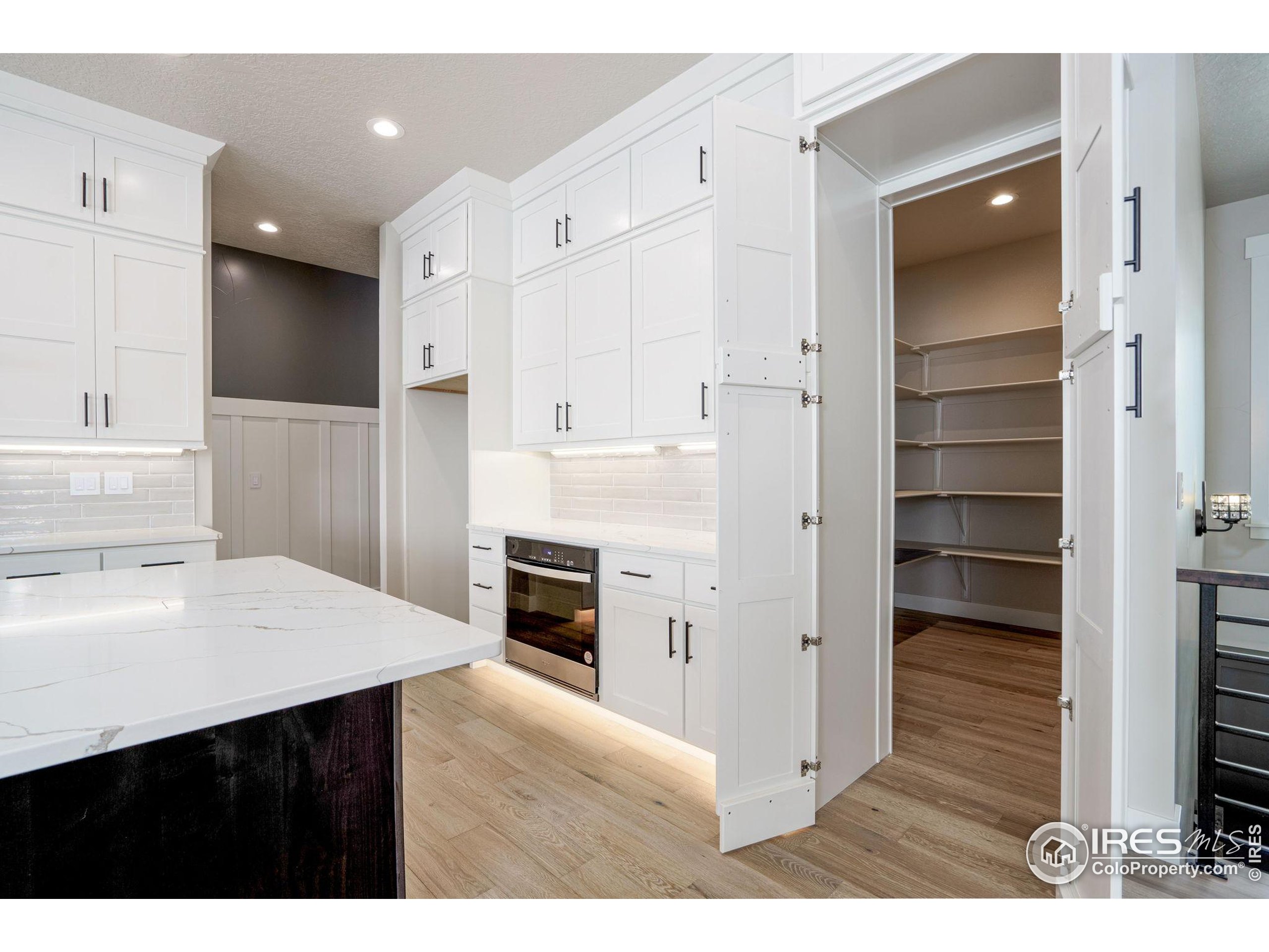 1369 Burt Avenue Berthoud, CO 80513 - Photo 11 of 41 a kitchen with cabinets and a refrigerator