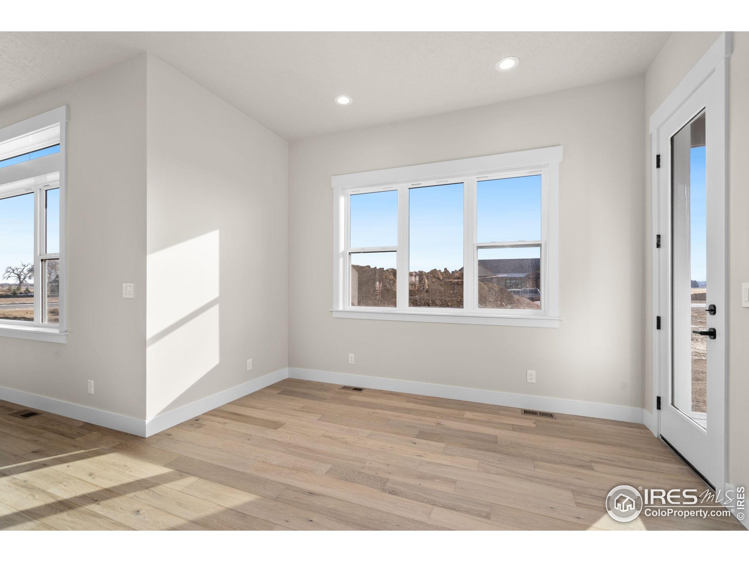 1369 Burt Avenue Berthoud, CO 80513 - Photo 14 of 41 a view of an empty room with wooden floor and a window