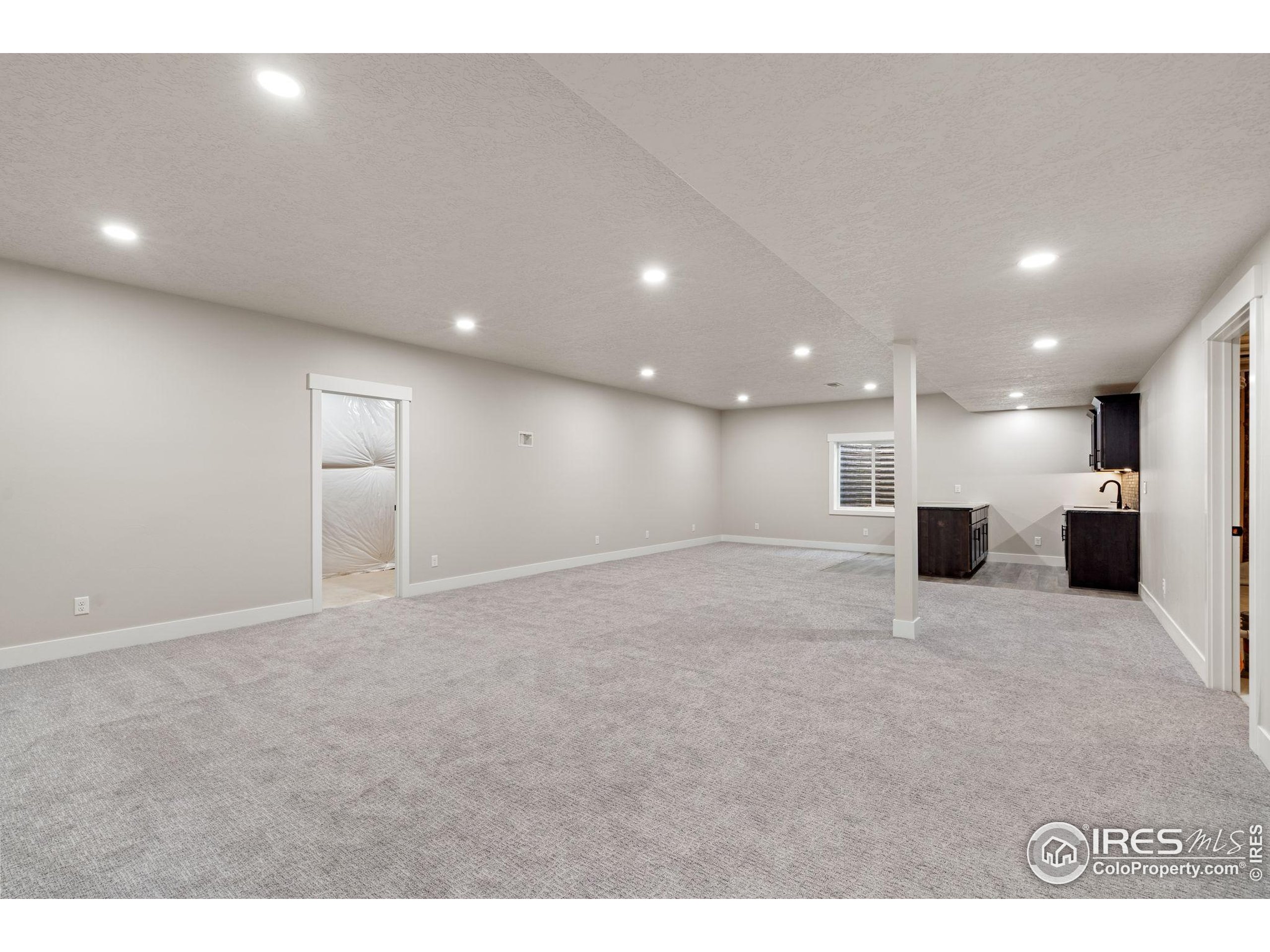 1369 Burt Avenue Berthoud, CO 80513 - Photo 29 of 41 a view of a big room with kitchen and chandelier
