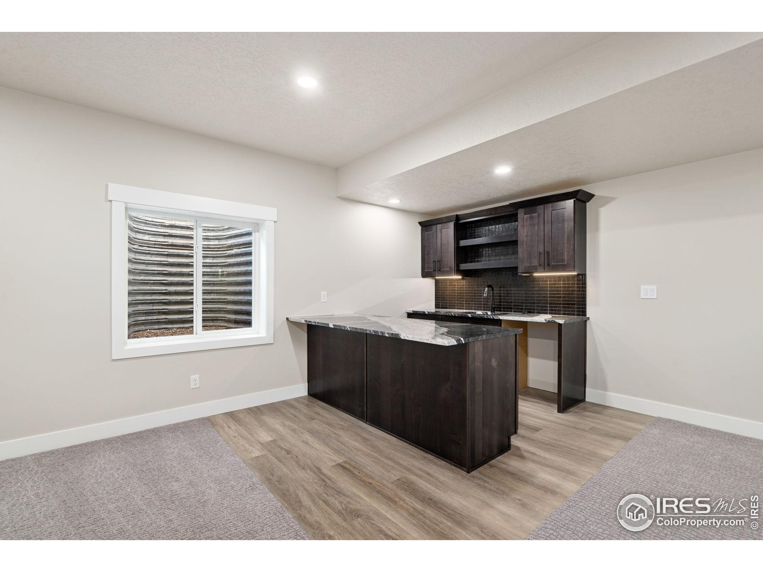 1369 Burt Avenue Berthoud, CO 80513 - Photo 31 of 41 a kitchen with stainless steel appliances granite countertop a stove a sink and a refrigerator