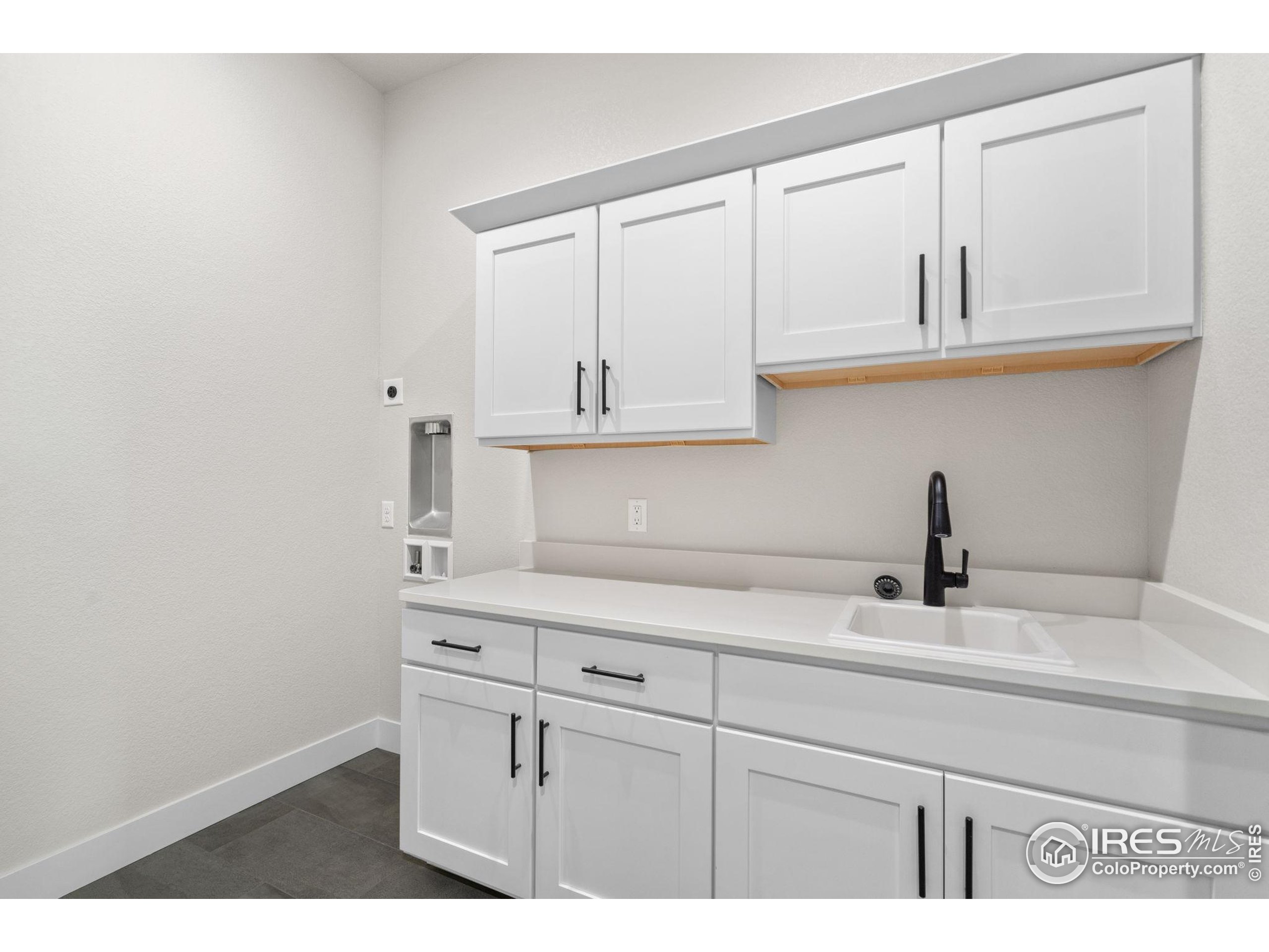 1369 Burt Avenue Berthoud, CO 80513 - Photo 37 of 41 a kitchen with white cabinets