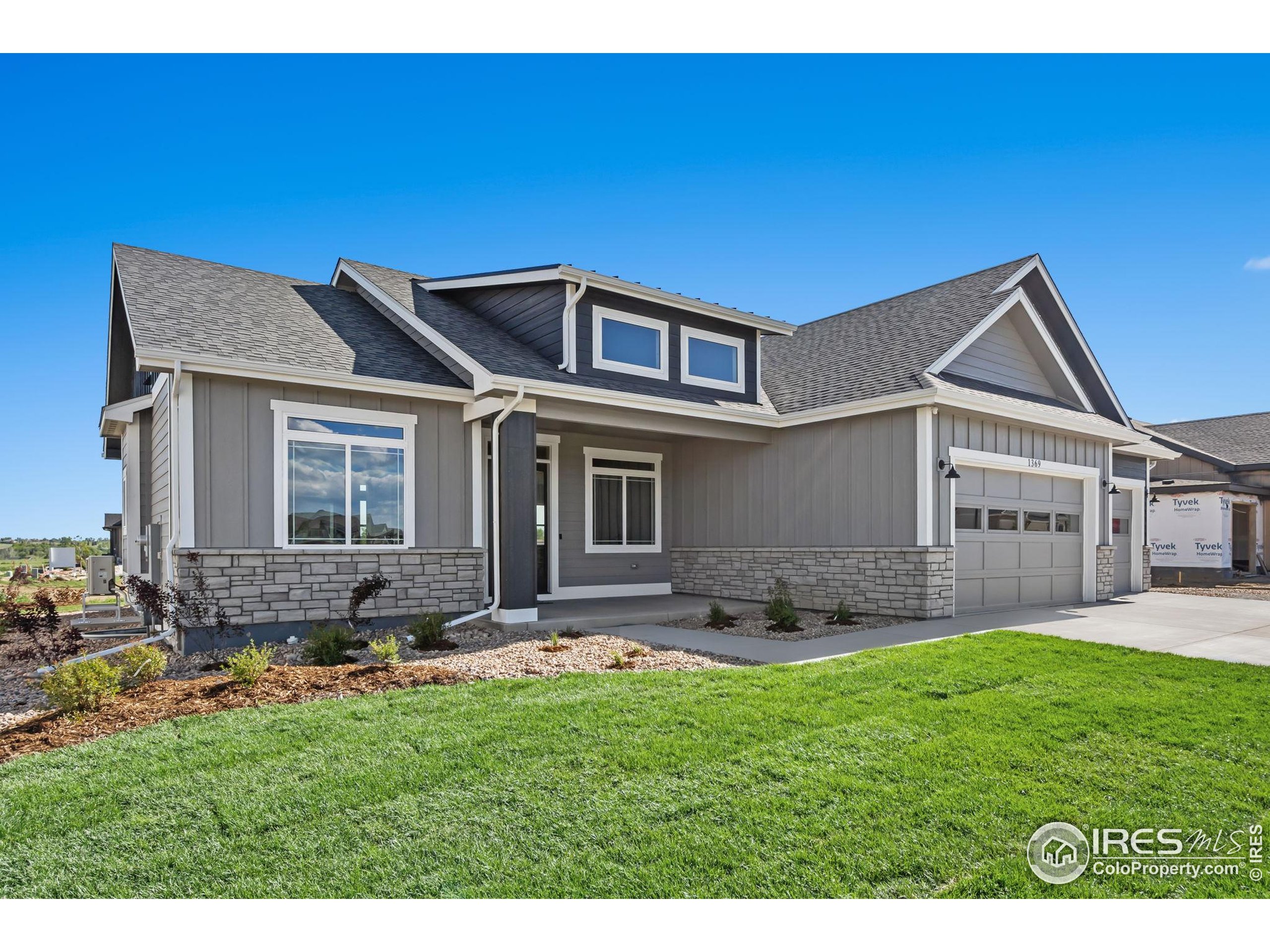 1369 Burt Avenue Berthoud, CO 80513 - Photo 38 of 41 a front view of a house with a yard and garage