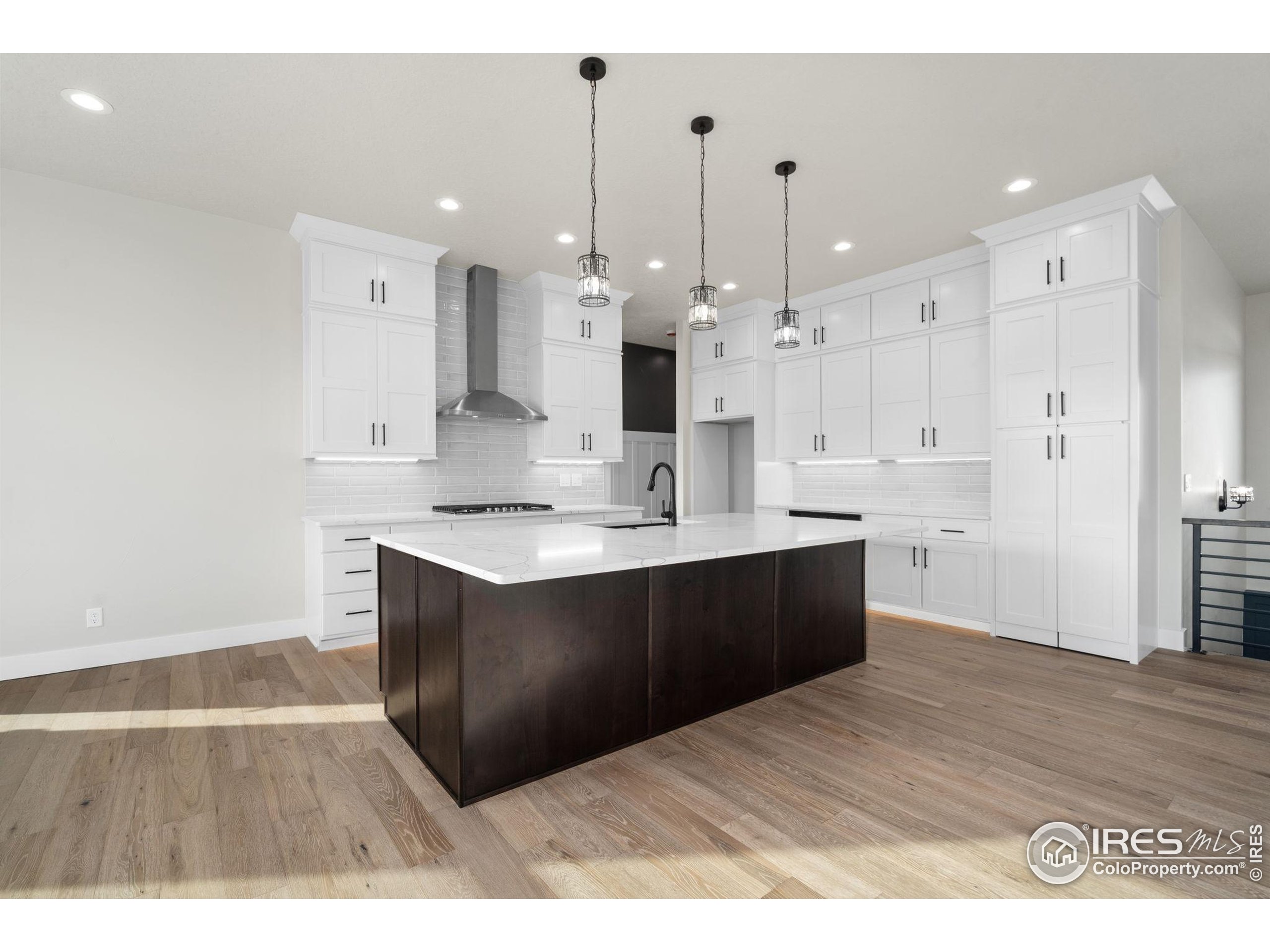 1369 Burt Avenue Berthoud, CO 80513 - Photo 7 of 41 a kitchen with a sink cabinets and wooden floor