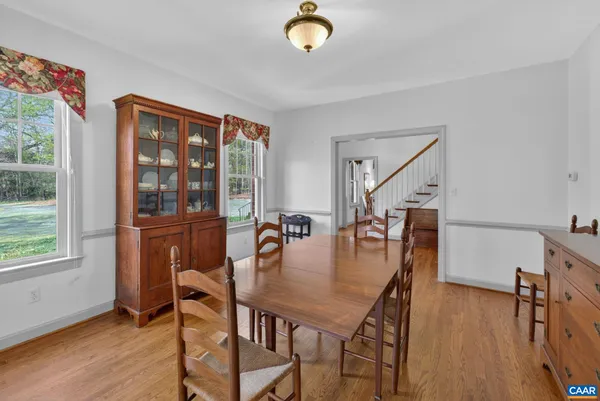 a dining room with furniture and wooden floor