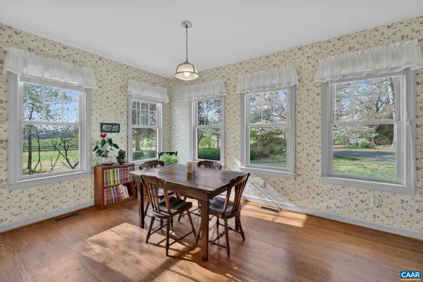 a view of a dining room with furniture window and wooden floor