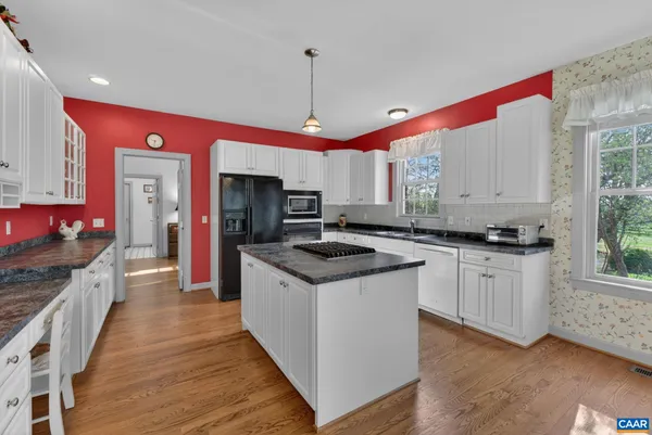a kitchen with stainless steel appliances granite countertop a stove and a sink