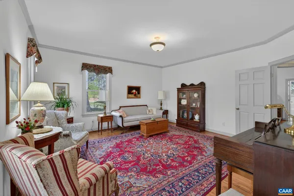 a bedroom with furniture and a wooden floor