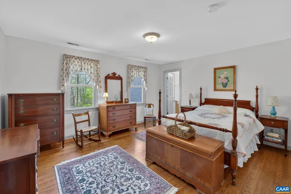 a bedroom with a bed dresser and a window