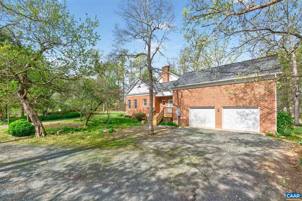 a view of a house with a yard and a tree
