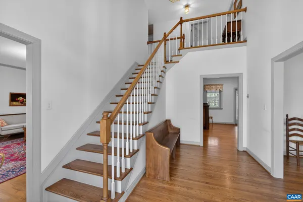 a view of entryway and hall with wooden floor