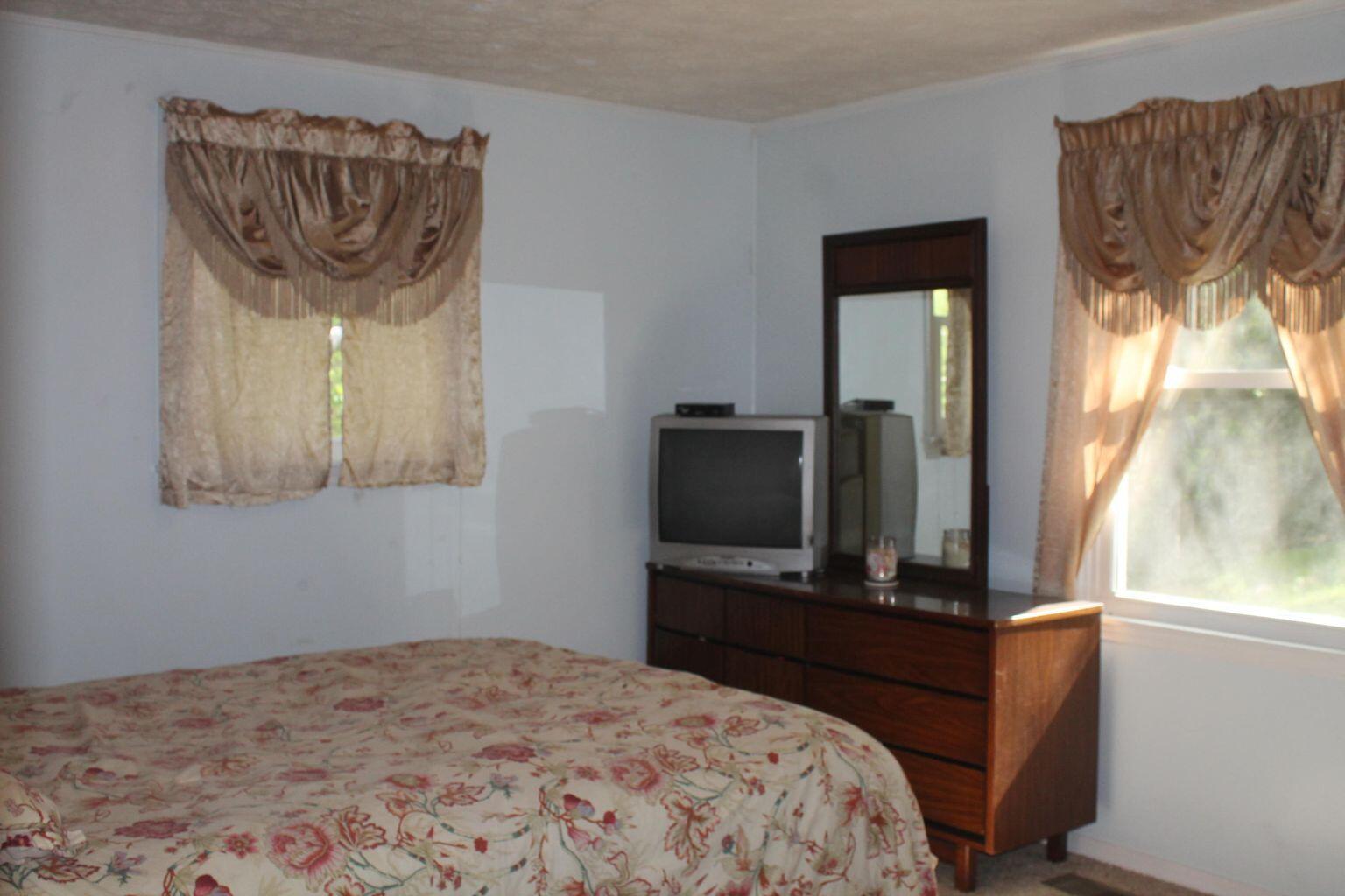 339 Howell Road Blue Ridge, VA 24064 - Photo 22 of 40 a bedroom with a bed and a television