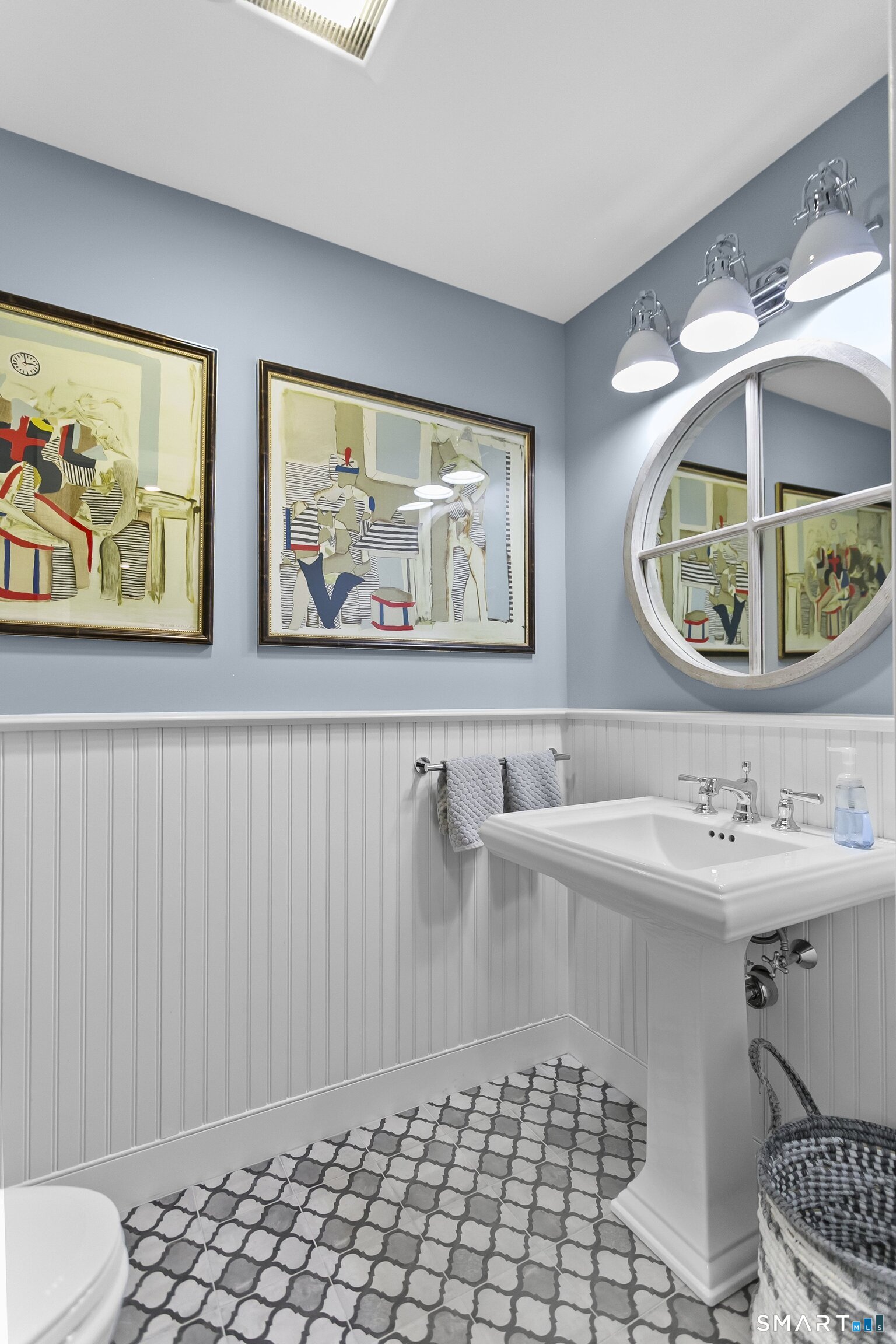 3007 Redding Road Fairfield, CT 06824 - Photo 35 of 40 a bathroom with a sink a mirror and a painting on the wall