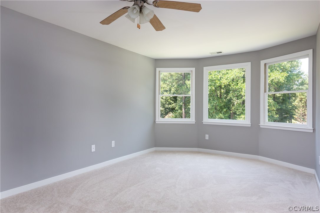 7613 Genuine Risk Lane Midlothian, VA 23112 - Photo 18 of 36 an empty room with a window and a fan