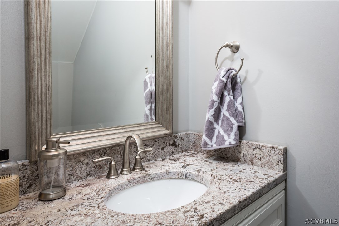 7613 Genuine Risk Lane Midlothian, VA 23112 - Photo 26 of 36 a bathroom with a granite countertop sink and a mirror