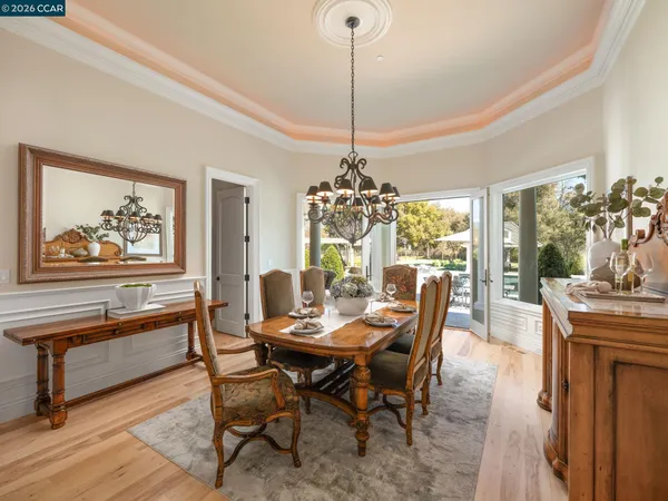 a kitchen with granite countertop white cabinets dining table and chairs