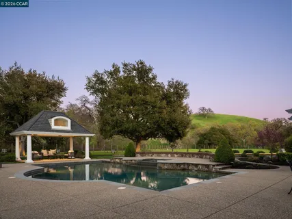 a view of house with outdoor space and garden
