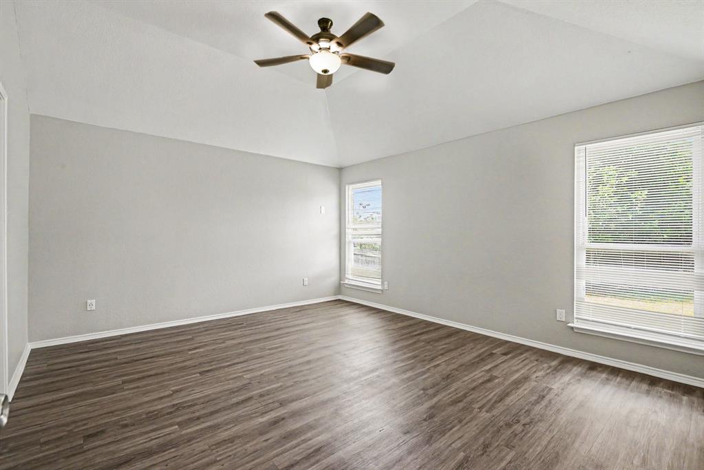 138 Kings Way Drive Rhome, TX 76078 - Photo 8 of 16 a view of empty room with wooden floor and fan