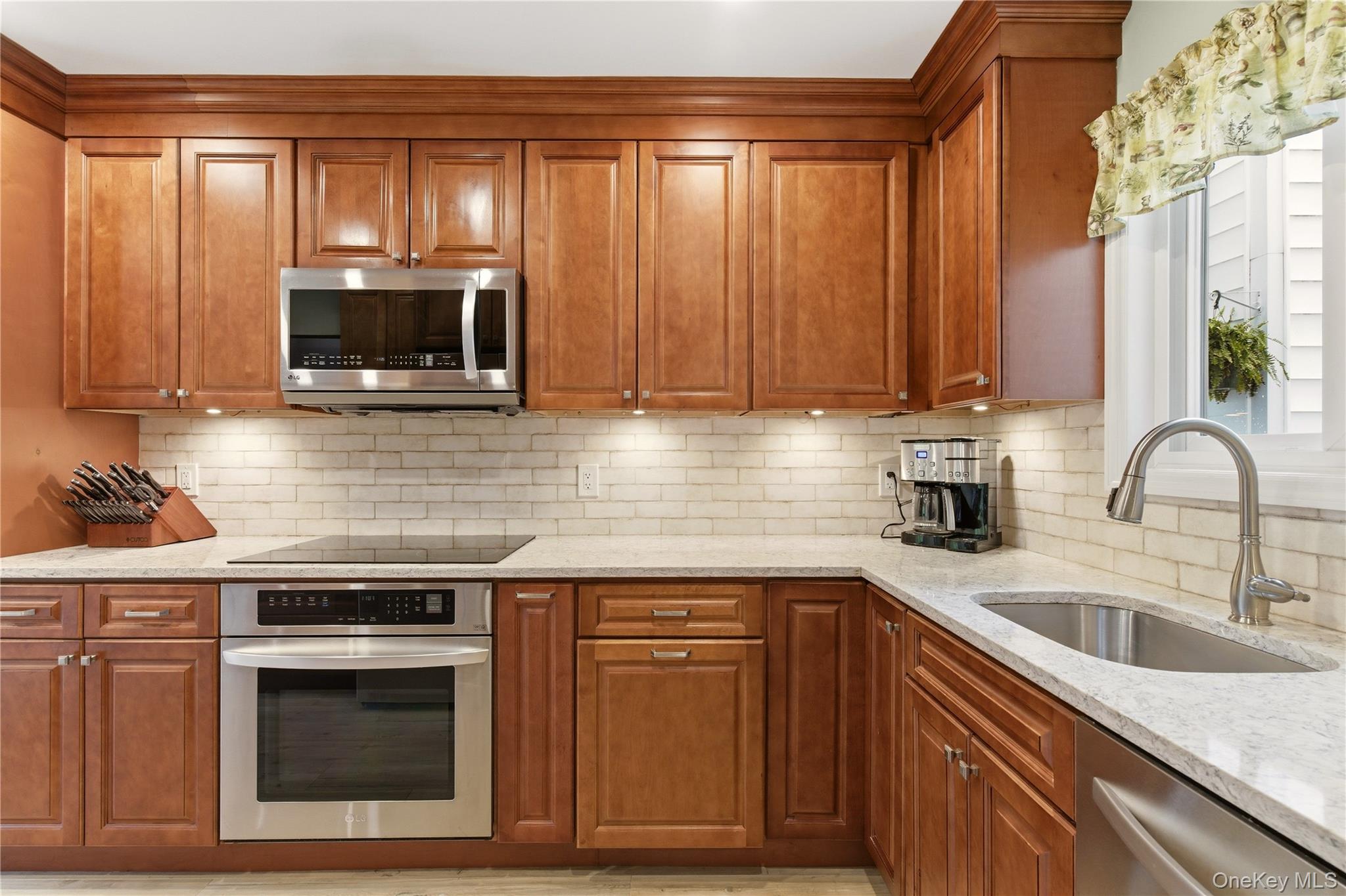 44 Hidden Ridge Drive Syosset, NY 11791 - Photo 7 of 28 a kitchen with granite countertop a stove a sink and a microwave