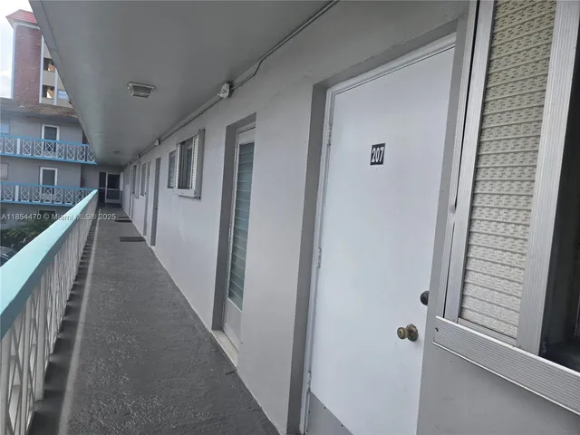 a kitchen with a white stove top oven and white cabinets