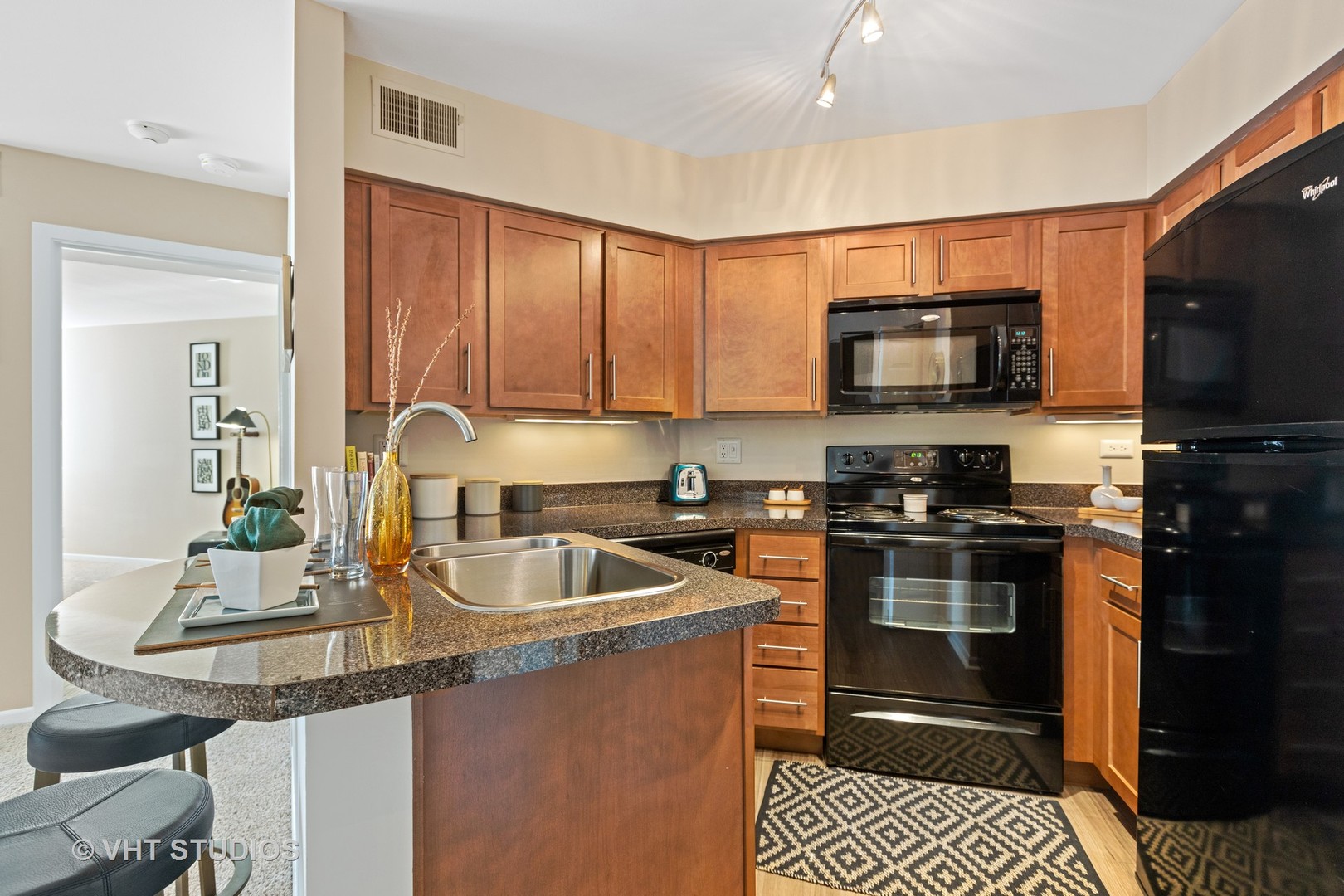 1919 Brookdale Road, Unit 108 Naperville, IL 60563 - Photo 25 of 53 a kitchen with a sink stove and microwave