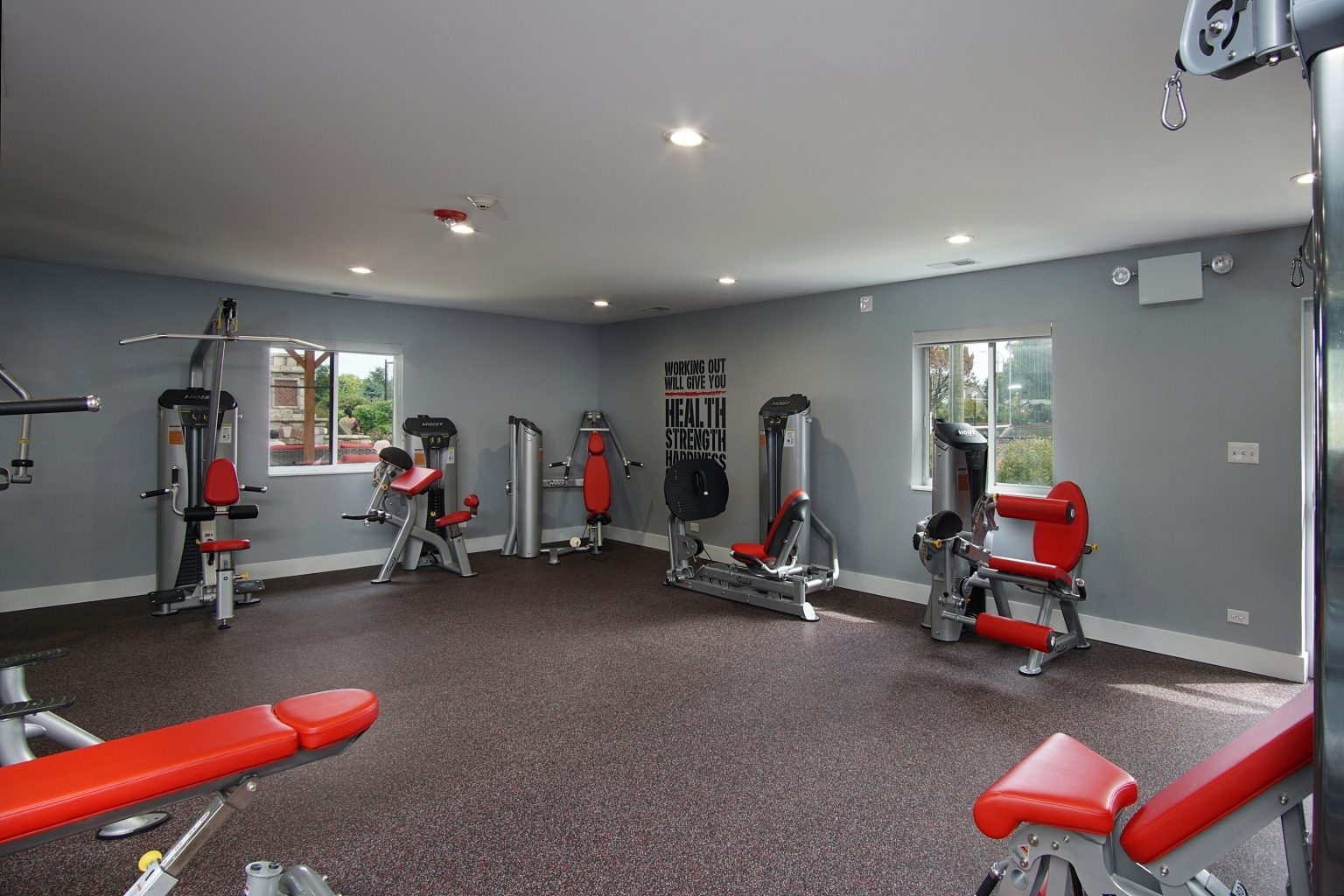 1919 Brookdale Road, Unit 108 Naperville, IL 60563 - Photo 4 of 53 a room with gym equipment and a table