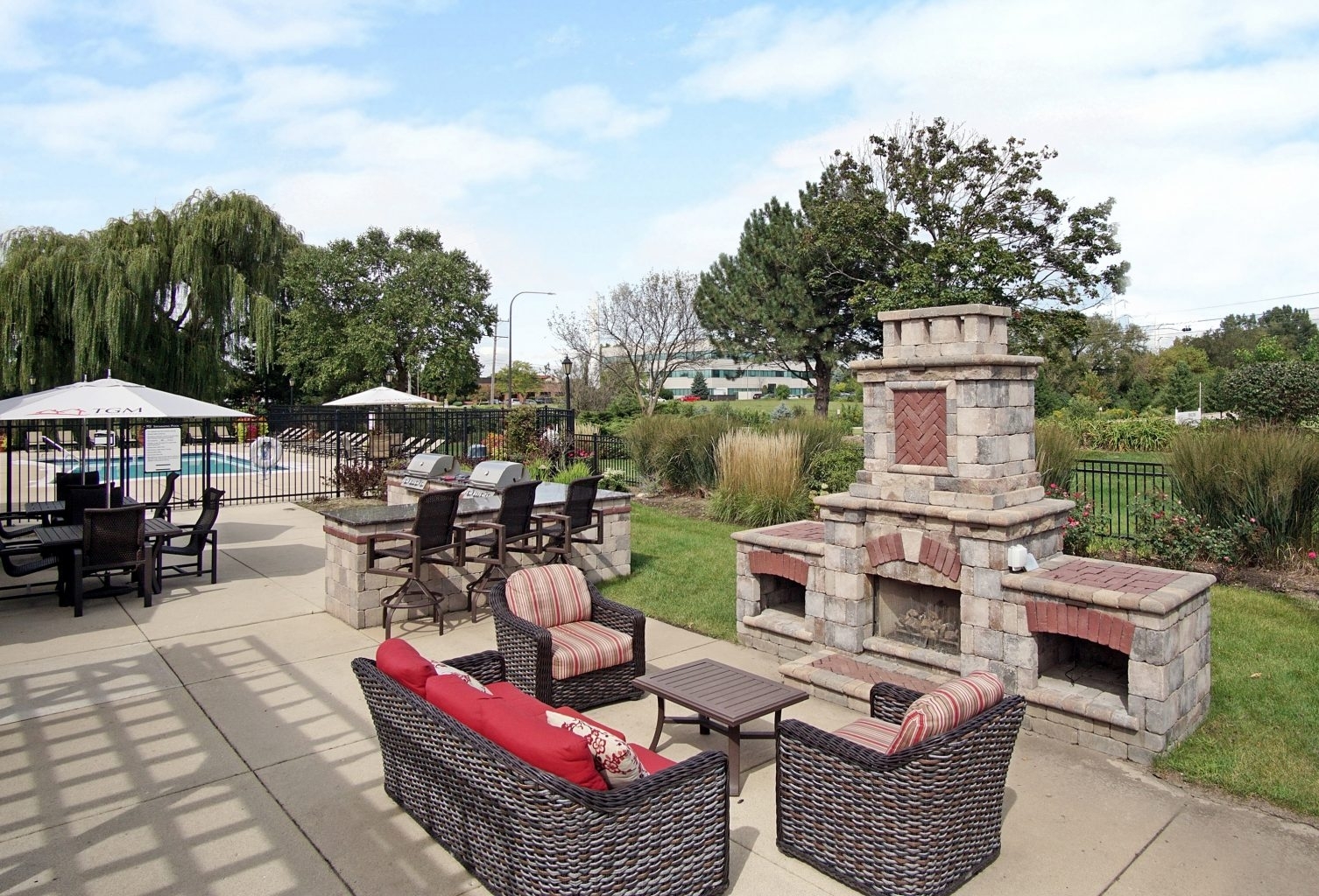 1919 Brookdale Road, Unit 108 Naperville, IL 60563 - Photo 7 of 53 a view of a patio with couches chairs and a fire pit