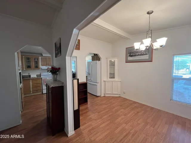 a view of a living room and kitchen with wooden floor