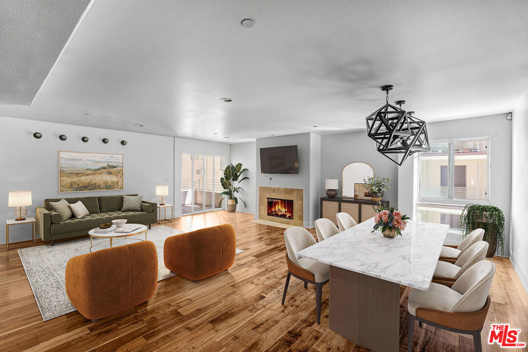 a living room with fireplace furniture and a wooden floor