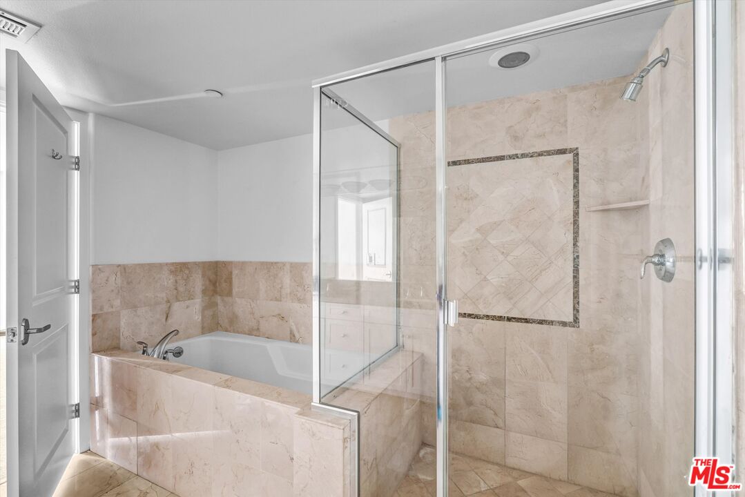 7249 Franklin Avenue, Unit 204 Los Angeles, CA 90046 - Photo 12 of 17 a bathroom with a bathtub and a shower