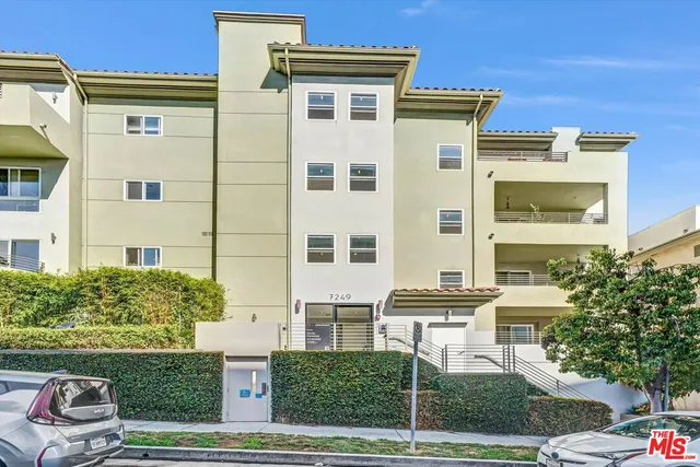 a view of a patio with a table and chairs and potted plants