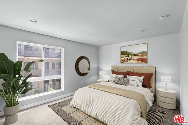 a bedroom with a large bed and a large window