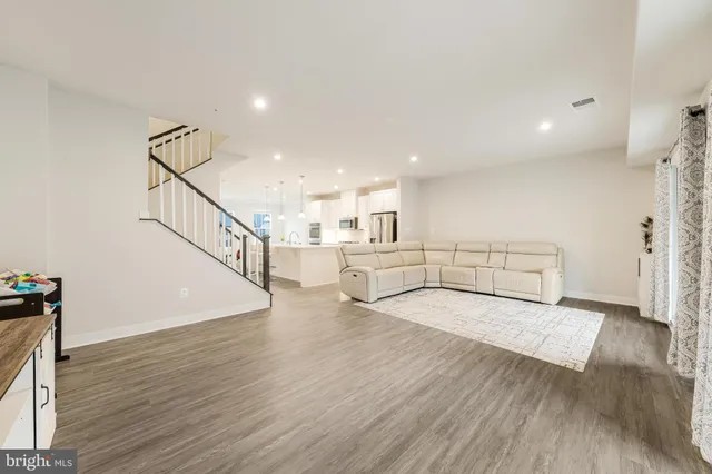 a view of a room with wooden floor and stairs