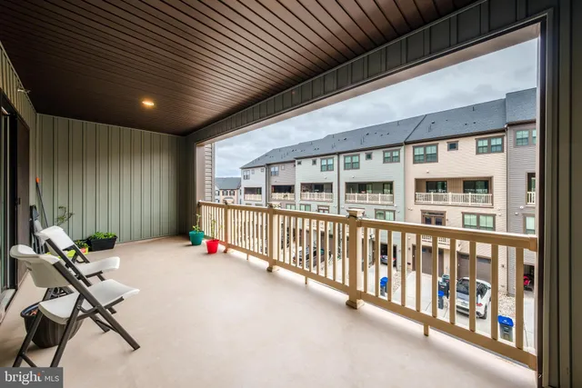 a view of a chairs and table in the balcony